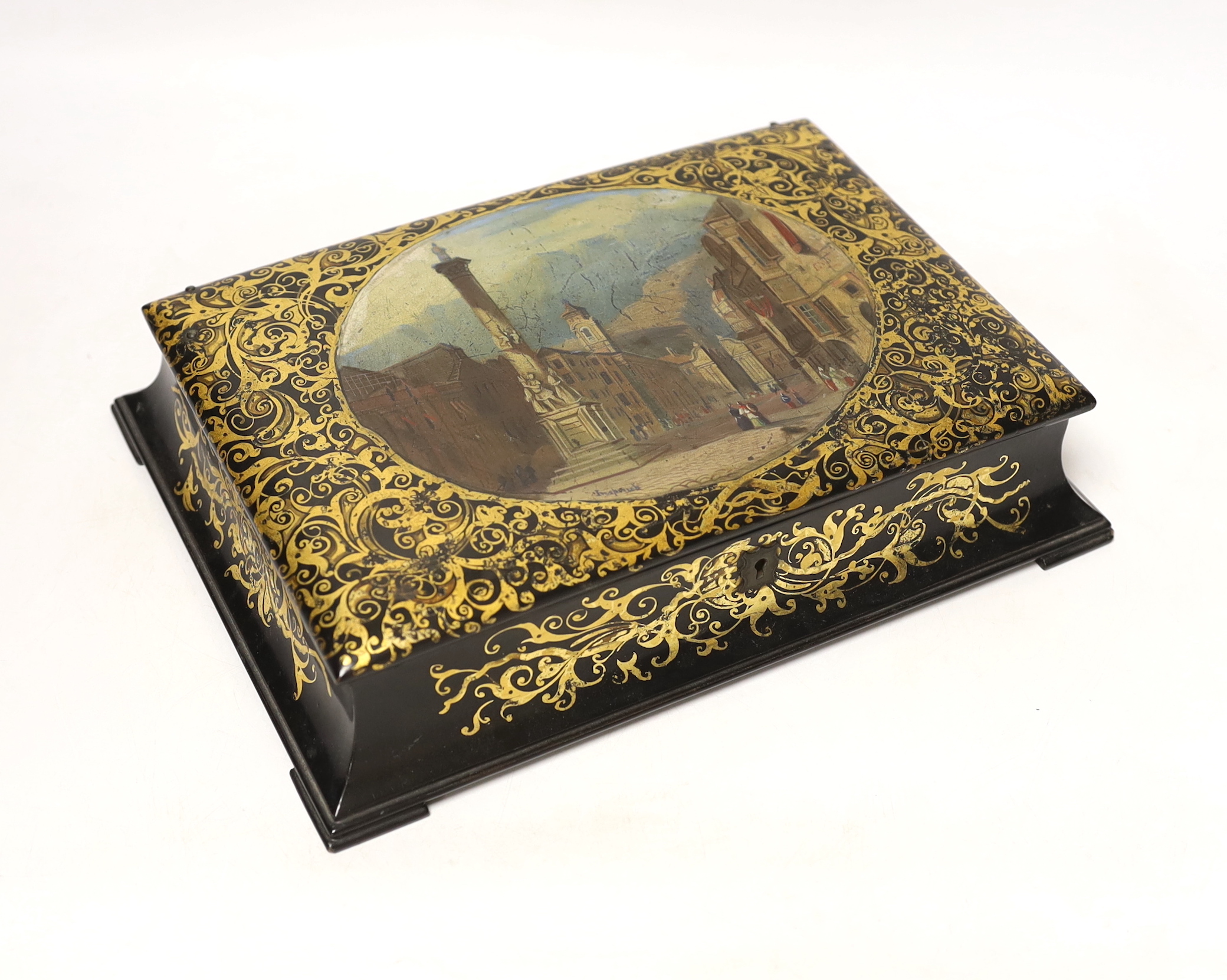 A Victorian stamped Jennens and Bettridge papier mache writing box, hand painted with a continental landscape with fitted watered silk interior, 27cm wide